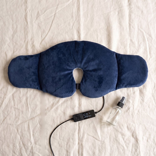 Full-face heating pad laid flat with its controller and mist bottle