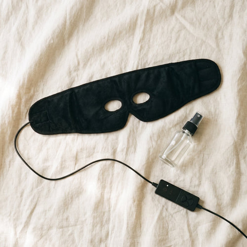 Heated sinus mask laid flat with its controller and mist bottle